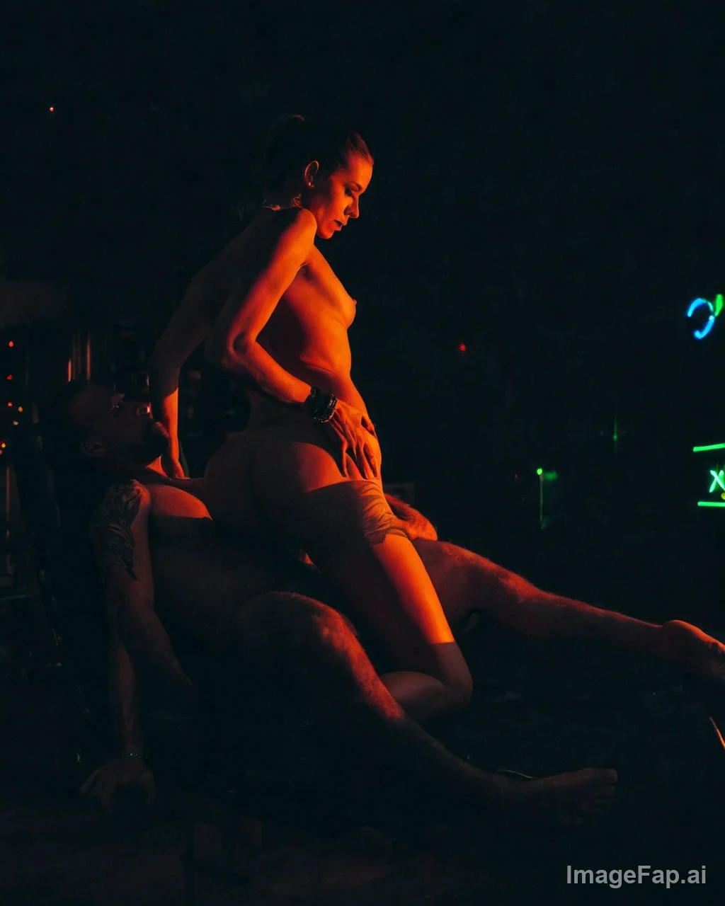 Two nude people in an intimate pose under warm orange and neon green